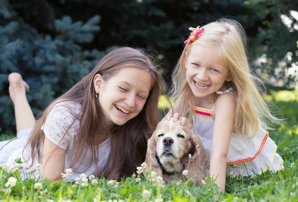 Two girls with dog — Stock Photo, Image