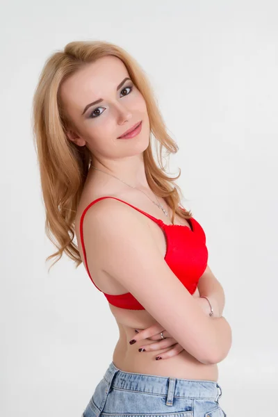 Beautiful young blonde in a red bra. — Stock Photo, Image