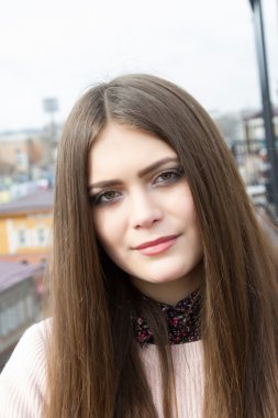 Şehrin arka plan üzerinde uzun saçlı genç kız