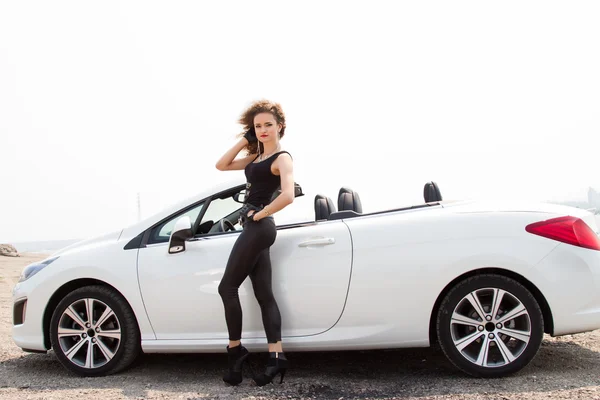 Young slim girl standing in convertible — Stock Photo, Image