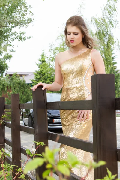 Young girl in an evening dress on a background cabriolet — Stock Photo, Image