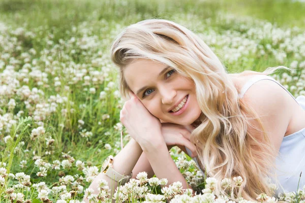 Blonde with long hair among wildflowers — Stock Photo, Image