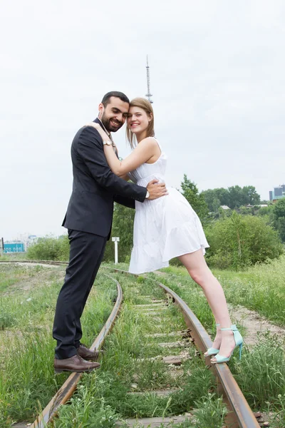 Two lovers are walking on railroad tracks — Stock Photo, Image