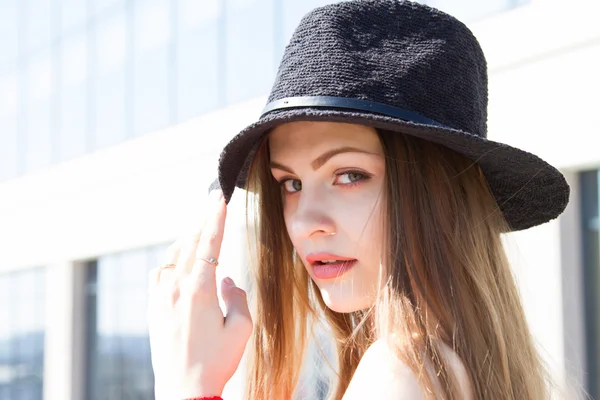 Beautiful girl in a red coat and black hat — Stock Photo, Image