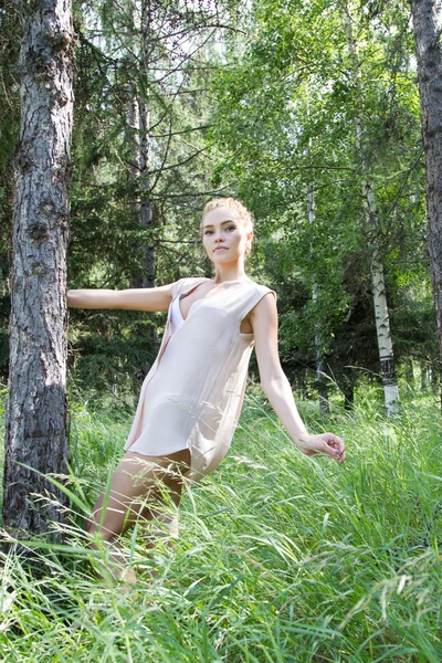 Beautiful young blonde in a summer forest — Stock Photo, Image