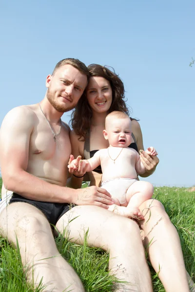 Family with a small child resting in nature — Stock Photo, Image