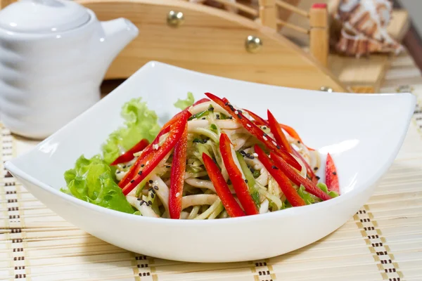 Squid with red pepper in a white dish — Stock Photo, Image