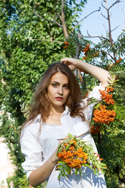 Girl in a white shirt with bunches of rowan — Stock Photo, Image