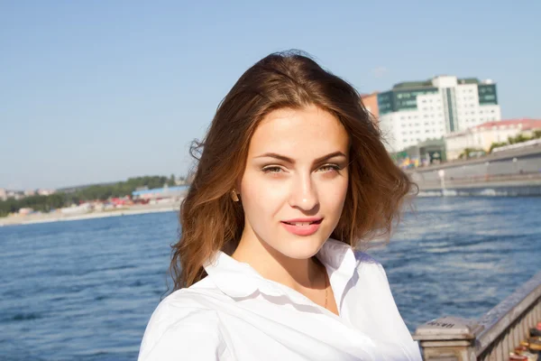 Business woman in white shirt standing on the river bank — Stock Photo, Image