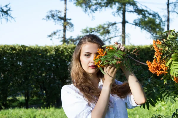 Young girl with a bunch of mountain ash — Stock Photo, Image