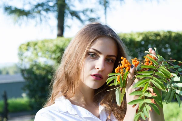 Young girl with a bunch of mountain ash — Stock Photo, Image