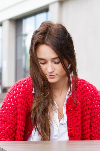 Young business woman in a red cardigan — Stock Photo, Image