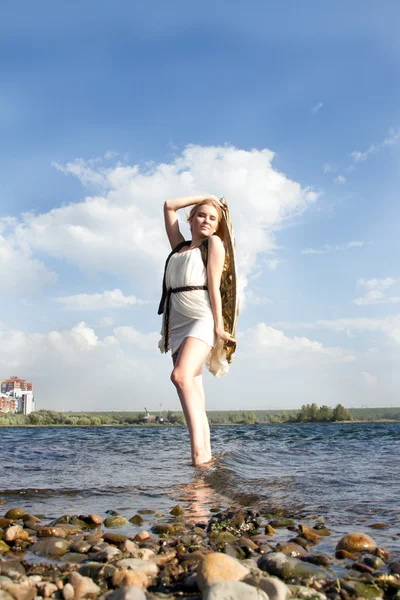 Girl in a white dress on the shore — Stock Photo, Image