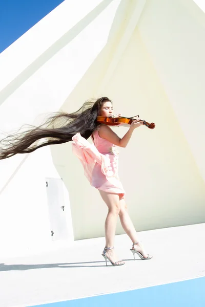 Violinista suona sul palco sotto il cielo aperto in un abito rosa — Foto Stock