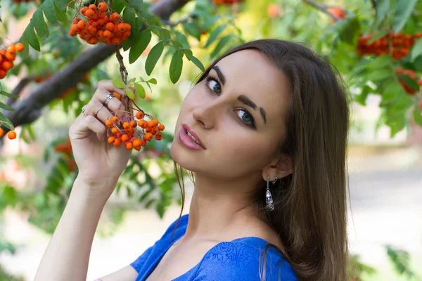 Young girl in the autumn forest with bunches of rowan — Stock Photo, Image