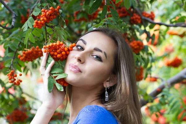 Young girl in the autumn forest with bunches of rowan — Stock Photo, Image