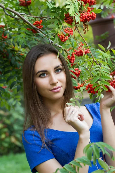 Young girl in the autumn forest with bunches of rowan — Stock Photo, Image