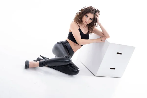 Young Girl Black Leather Pants Sits Cube Studio Portrait White — Stock Photo, Image