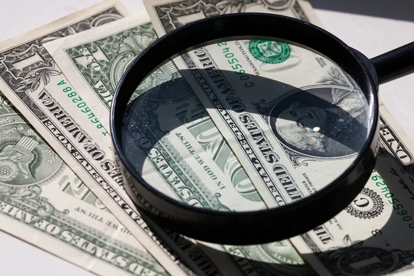 American dollar through a large magnifying glass — Stock Photo, Image