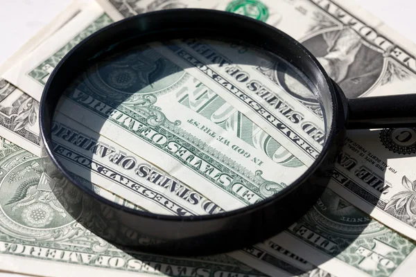 American dollar through a large magnifying glass — Stock Photo, Image