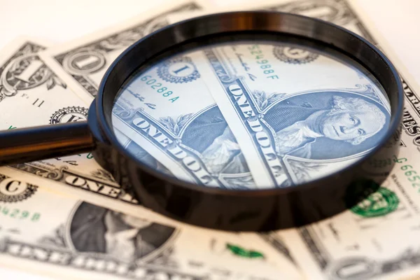 American dollar through a large magnifying glass — Stock Photo, Image