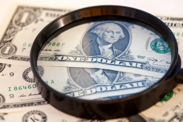 American dollar through a large magnifying glass — Stock Photo, Image