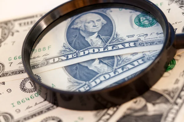 American dollar through a large magnifying glass — Stock Photo, Image