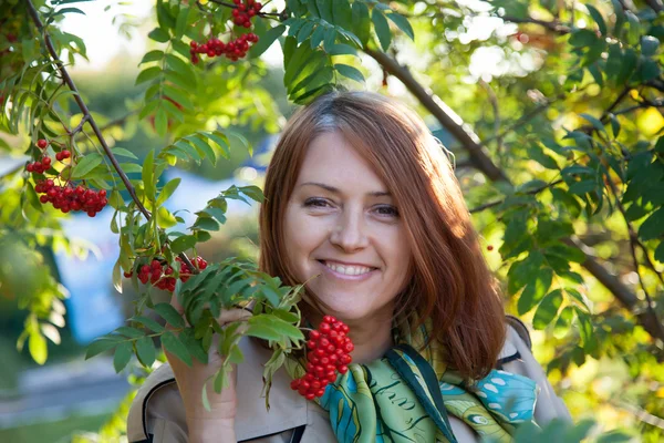 Woman with a branch of a mountain ash — Stock Photo, Image