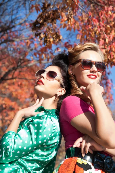 Two girls on a background of autumn trees — Stock Photo, Image