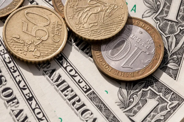 Euro coins and the ruble against the backdrop of the American dollar — Stock Photo, Image