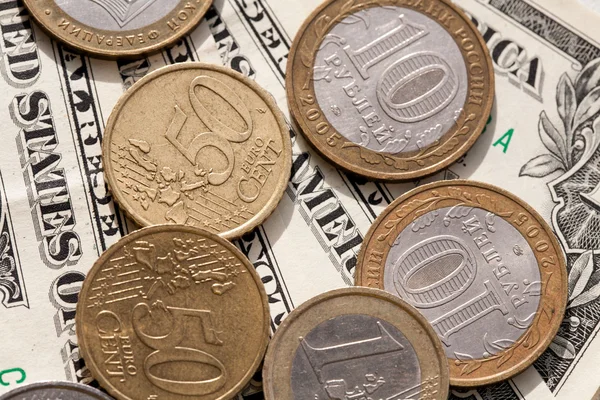 Euro coins and the ruble against the backdrop of the American dollar — Stock Photo, Image