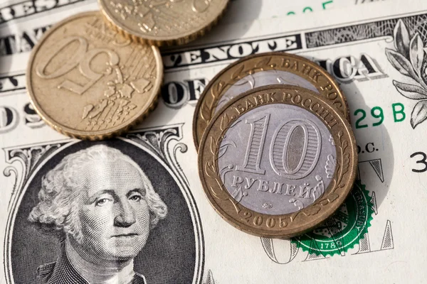 Euro coins and the ruble against the backdrop of the American dollar — Stock Photo, Image