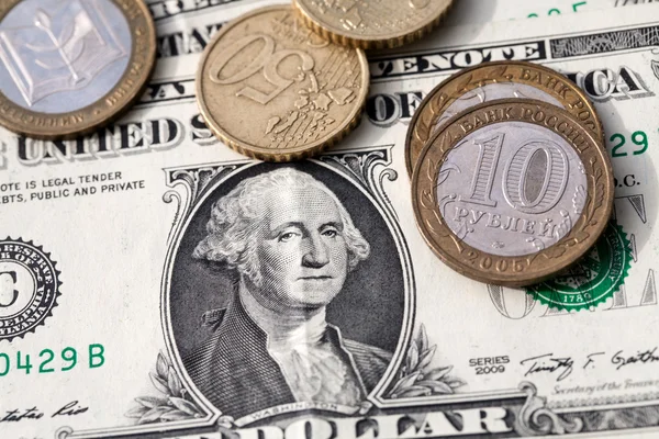 Euro coins and the ruble against the backdrop of the American dollar — Stock Photo, Image