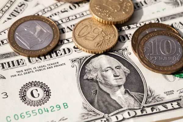 Euro coins and the ruble against the backdrop of the American dollar — Stock Photo, Image