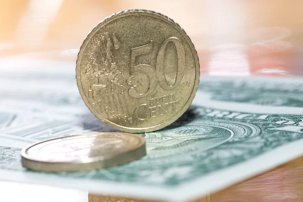 Euro coins on a background of dollars — Stock Photo, Image