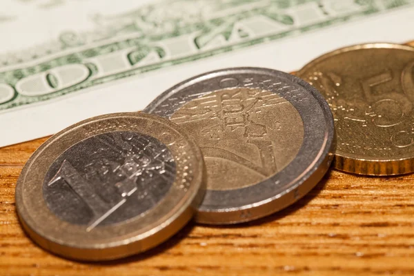 Euro coins on a background of dollars — Stock Photo, Image