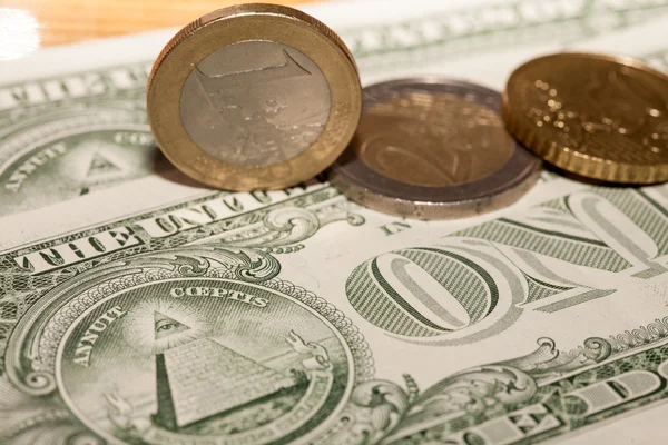 Euro coins on a background of dollars — Stock Photo, Image