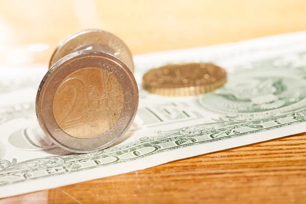 Euro coins on a background of dollars — Stock Photo, Image
