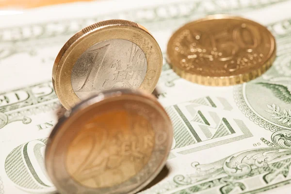 Euro coins on a background of dollars — Stock Photo, Image