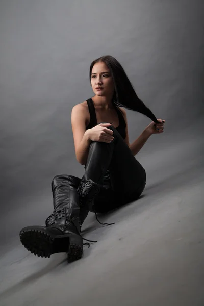 Girl in leather pants and boots — Stock Photo, Image