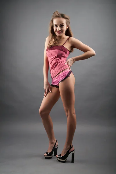 Studio portrait of a young girl in pink lingerie — Stock Photo, Image