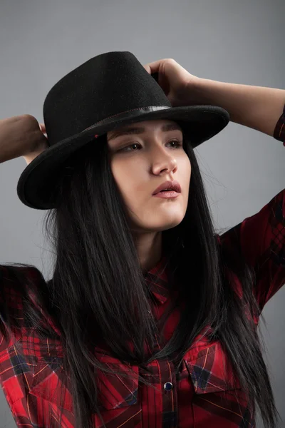 Girl in black hat. studio portrait — Stock Photo, Image