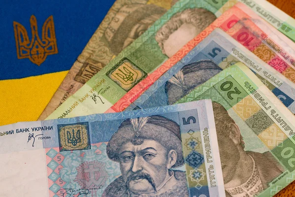 Ukrainian money against the background of the national flag — Stock Photo, Image