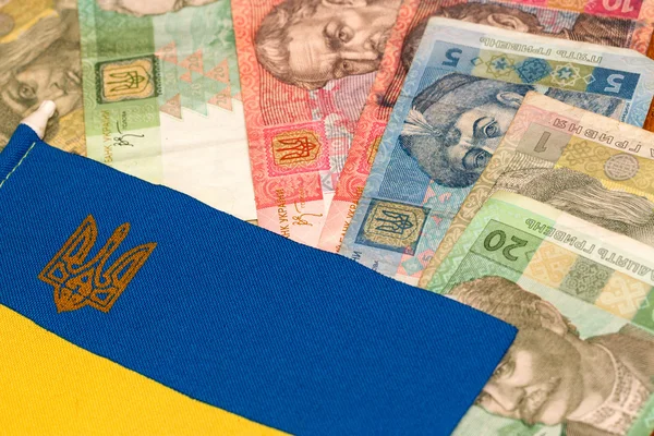 Ukrainian money against the background of the national flag — Stock Photo, Image