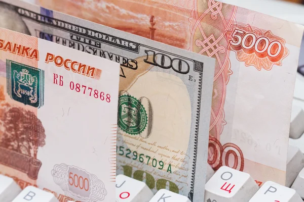 Russian rubles and US dollars on a computer keyboard. Wire transfers