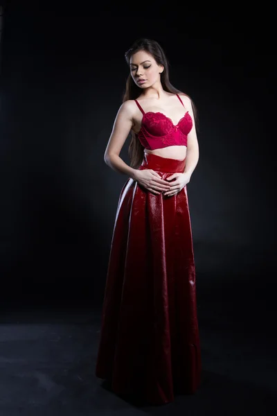 Young girl in a red skirt and bra — Stock Photo, Image