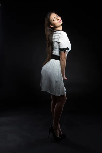 Girl in white dress on a black background — Stock Photo, Image