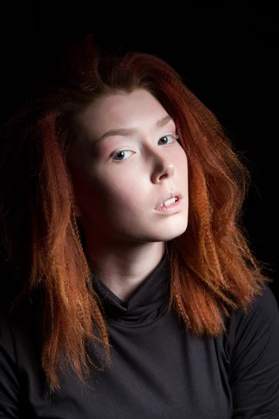 Girl with red hair on a black background — Stock Photo, Image