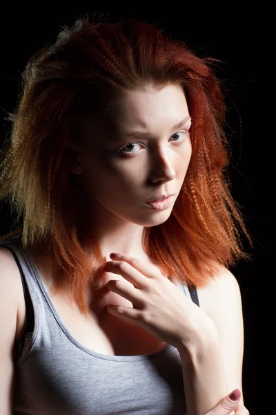 Girl with red hair on a black background — Stock Photo, Image