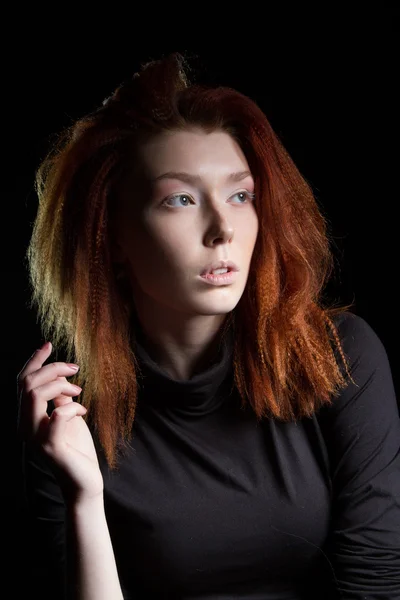 The girl with red hair on a black background — Stock Photo, Image